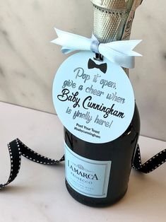 a bottle of wine with a bow tied to it's neck and label that says do not open give a green when baby congratulations