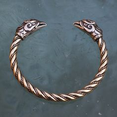 Please note that we only ship via FedEx (outside of the EU) and DPD (within the EU). The price is dependent on those carrier services' price lists. GRIFFIN, brass bracelet of our own design. It can be adjusted by bending. Griffin (also griffon or gryphon) is a legendary creature. It has a lion body, tail and back legs, while the wings and head belong to an eagle. Product of Wulflund, copyright. -   Material: brass Please note that FedEx does NOT deliver to PO boxes! Viking Style Handmade Gold Jewelry, Handmade Viking Gold Jewelry, Handmade Viking Style Gold Jewelry, Viking Style Silver Bangle Bracelet, Viking Style Engraved Jewelry For Larp, Viking Style Handmade Bracelets As Gift, Viking Style Bronze Jewelry Gift, Bronze Viking Jewelry Collectible, Handmade Viking Style Bracelets For Gifts