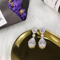 "These stud bridal earrings are stunning for bridal occasions whether you want a vintage or classic look. These beauties are designed with encrusted crystals and high quality AAA+ cubic zirconia that glistens on the ear. They come in a sparkling silver, gold or rose gold finish to give an elegant look. These gorgeous earrings will be carefully wrapped and arrive in a logo gift box. Visit my shop for care instructions and more bridal accessories ➔ https://www.etsy.com/shop/BlushandIvoryStudio Mea Elegant Wedding Clip-on Earrings With Sparkling Stones, Diamond White Pear-shaped Bridal Earrings For Evening, Gold Diamond Teardrop Earrings For Wedding, Elegant Crystal Clip-on Earrings For Wedding, Gold Teardrop Earrings With Diamond Accents For Wedding, Elegant Diamond White Clip-on Earrings For Wedding, Elegant Diamond White Clip-on Wedding Earrings, Pear-shaped Earrings With Diamond Accents For Wedding, Pear-shaped Diamond Accent Earrings For Wedding