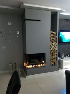 a living room with a fire place and television on the wall in front of it