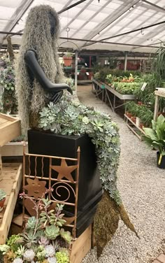 an outdoor garden center with plants and flowers