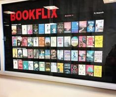 there is a large poster on the wall with books written in red and black letters