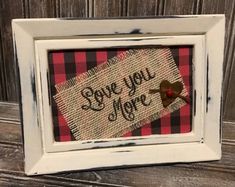 a white frame with a red and black plaid pattern on it that says love you