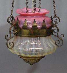 a pink and yellow glass hanging light fixture