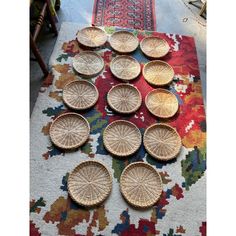 several woven baskets sitting on top of a rug