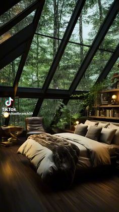 a bed sitting inside of a bedroom on top of a wooden floor next to a window