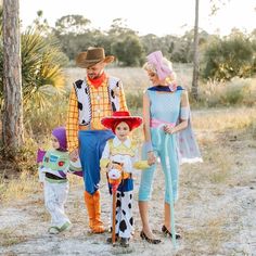 three people dressed up as toy story characters and one is holding a child's hand