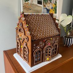 a gingerbread house is displayed on a table