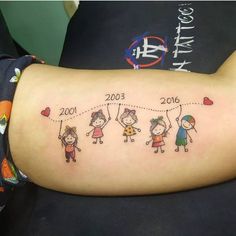 a woman's arm with an image of children and their birth dates on it