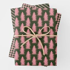 pink christmas trees on green wrapping paper with brown ribbon and checkerboard pattern background