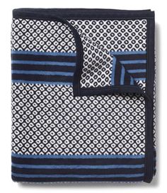 a blue and white blanket with black trim