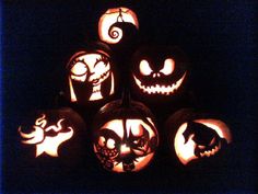 pumpkins with faces carved into them in the dark