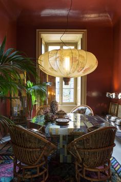 the dining room table is surrounded by wicker chairs and rattan - like chairs