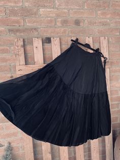 "This is an old underskirt, a petticoat, I guess from 30's, tailored and hand-stitched, black silk or satin with ruffles. In the past it was wearing under the clothes to \"puffing\", to give volume to the lower part of the clothes with very narrow waist. It can be also wear as is with texani boots for a gorgeous cow-girl style ! or with doc marten's and black leather jacket for a rockers look SO COOL SIZE unknown Approx measures : Waist line 11.82\" hips line 24.43\" hem line 43.34\" Length 30.3 Evening Long Skirt With Attached Cancan, Black Dress With Ruffles And Long Skirt, Black Long Ruffled Skirt Petticoat, Black Long Ruffled Petticoat, Black Flared Dress With Ruffles, Black Dress With Voluminous Long Skirt, Black Dress With Gathered Skirt, Black Skirted Dress With Gathered Skirt, Black Full Skirt Dress With Attached Cancan