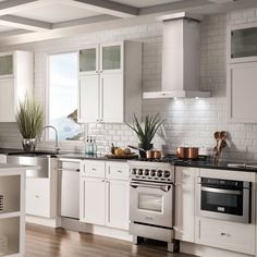 a kitchen with white cabinets and stainless steel appliances