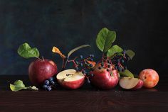 an arrangement of fruit including apples and blueberries