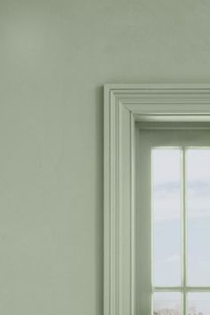 an open window in a white room with green walls