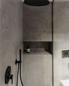 a bathroom with a shower head, sink and faucet next to the bathtub