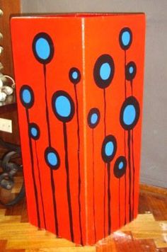 an orange box with blue dots on it sitting on top of a hard wood floor