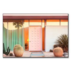 a pink door and cactus in front of a house