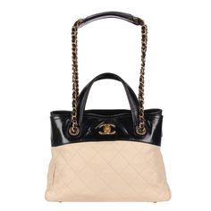 Authentic, pre-owned Chanel black and beige quilted leather shoulder bag. This stylish and classic tote features diamond-stitched grained calfskin leather in beige with black trim. The shoulder bag features a leather top handle, a leather-threaded gold chain-link shoulder strap, and a gold CC turn-lock closure. The bag opens to an interior with 2 large pockets, a middle zipper pocket, a side zipper pocket, and 2 slip pockets, and bottom 4 feet. Strap drop: 9.5 removable Hologram stamp reads: 160 Designer Quilted Top Handle Bag, Luxury Shoulder Bag With Chain Strap And Top Handle, Chanel Bag Top Handle, Designer Gold Quilted Shoulder Bag, Gold Quilted Top Handle Bag, Chanel Coco Handle, Coco Handle, Leather Formal Shoes, Timeless Bags