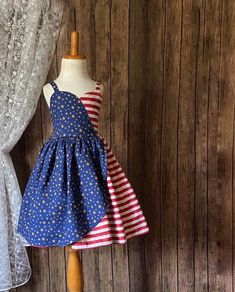 Your child can feel like a star. In their knee length patriotic dress ,made of 100% cotton, features a sweetheart bodice and elastic back for everyday comfort Sizing: Length is measured armpit to knee . See photos for sizing chart and how to measure.  Shipping :  Please allow 2-4 weeks   for this order to be shipped. All Items are shipped priority USPS mail. If you need it by a certain date, please check with me before making a purchase. I DO NOT DROP SHIP OR SHIP OUTSIDE OF THE USA  Photos:  Fa Patriotic Blue Dresses For 4th Of July, Blue Patriotic Cotton Dress, Patriotic Blue Cotton Dress, Blue Cotton Patriotic Dress, Fitted Sleeveless Dress For 4th Of July, Red Patriotic Dress For 4th Of July, Patriotic Red Dresses For 4th Of July, Patriotic Blue Sleeveless Dress, Patriotic Sleeveless Red Dress