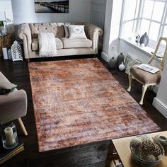 a living room filled with furniture and a large rug