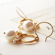 Pearl Earrings, Bridal Earrings, Wedding Jewelry, Bridesmaid EarringsTordu in French means twisted metal.  This piece of gold plated twisted metal is what is so beautiful about this earring.  A vintage glass pearl coupled with smaller freshwater pearls make a lovely classic earring for the bride.+ Vintage Glass Pearl. Freshwater Pearls. 14K Gold Fill Ear Wire.+ Earrings measure 1.75 inches (4.44 cm) in length.+ Earrings are ready to ship.+ Your jewelry will come in a jewelry box, tied with a rib Gold Drop Earrings As Wedding Gift, Gold Drop Earrings For Wedding Gift, Delicate Gold Cluster Earrings For Anniversary, Elegant Gold Bridal Earrings For Wedding Gift, Gold Bridal Earrings With Ear Wire For Anniversary, Elegant Brass Hoop Earrings For Wedding, Gold Cluster Earrings With Ear Wire For Anniversary, Elegant Brass Bridal Earrings For Wedding, Gold Hoop Earrings With Ear Wire For Wedding