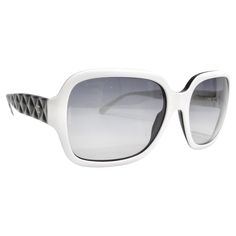 Introducing the Chanel Acetate Quilted CC Sunglasses, a stunning addition to your eyewear collection. This sophisticated pair features a striking white and black frame with large squared rims and grey-tinted lenses, offering a bold and fashionable look that seamlessly balances style and functionality. The unique design is elevated by the black faux quilted arms, reminiscent of Chanel's iconic quilted pattern, adding texture and depth to the overall aesthetic. A small gold tone Chanel CC logo sub Chanel Eyeglasses 2022, Elegant Optic White Polarized Sunglasses, Elegant Optic White Sunglasses With Tinted Lenses, Trendy White Acetate Sunglasses, Chic White Square Frame Sunglasses, Chic White Sunglasses For Formal Occasions, Elegant White Sunglasses For Formal Occasions, White Acetate Sunglasses With Gradient Lenses, White Acetate Sunglasses With Polarized Lenses