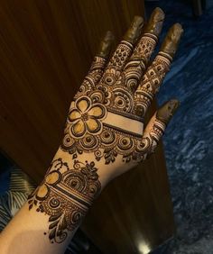 a woman's hand with henna on it