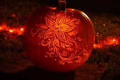 a carved pumpkin sitting on top of a field