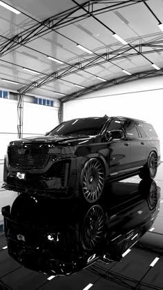 a black and white photo of a car in a garage