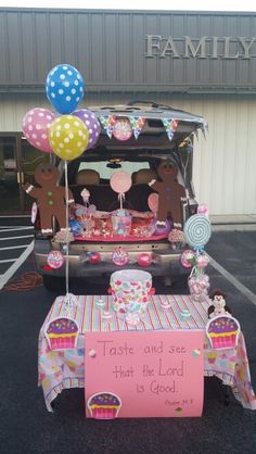 the trunk of a car is decorated with balloons and candy