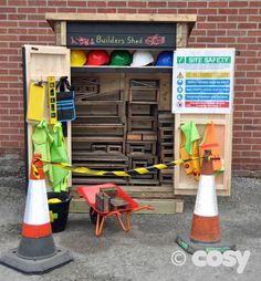 there are some construction cones in front of the building with it's doors open