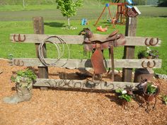 an old wooden bench with some tools attached to it in the grass next to a play ground