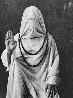 an old photo of a person wearing a veil and holding their hands up in the air