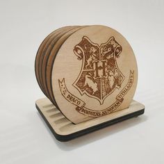 a wooden coaster with the hogwarts crest engraved on it