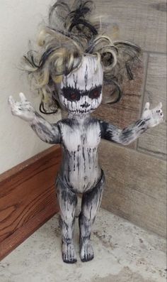 a creepy doll is standing in front of a wall with hair on it's head