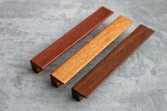 three wooden handles on top of each other