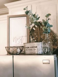 a metal refrigerator freezer sitting on top of a wooden shelf next to a basket