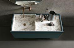 a bathroom sink with a marble counter top and matching faucet in the middle