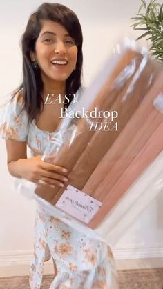 a woman is holding two packages of cake in her hands and smiling at the camera