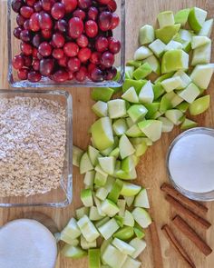 apples, cranberries, cinnamon sticks and oatmeal are arranged on a cutting board