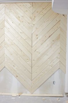 an unfinished wood paneled wall in a room