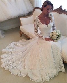 a woman in a wedding dress sitting on a couch