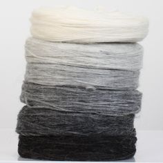 several skeins of wool sitting on top of each other