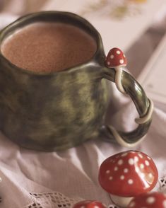 a cup of hot chocolate next to some mushrooms