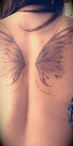 the back of a woman's breast with wings drawn on her shoulder and chest