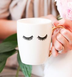 This Eyelash Coffee Mug is the perfect gift for that special someone who loves lashes! You'll be sure to make them smile with this unique and stylish mug. The mug is handmade from unbreakable ceramic, making it durable enough to last a lifetime. It's decorated with beautiful eyelashes, adding an extra touch of fun and personality. With its sleek design and comfortable handle, you can enjoy your favorite drinks in style. Whether you're sipping coffee or tea, this mug will keep your beverages hot Painted Coffee Cup, Gifts For Makeup Lovers, Water Decor, White Eyelashes, Tout Rose, Eyelash Logo, Sweet Water, Beautiful Eyelashes, Lash Room