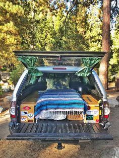 the back end of a truck with a bed in it